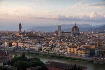 Florence romantic panoramic view from above during a coloured sunset on buildings Duomo churches and Ponte Vecchio