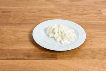 Plate of mozzarella on a wooden table.