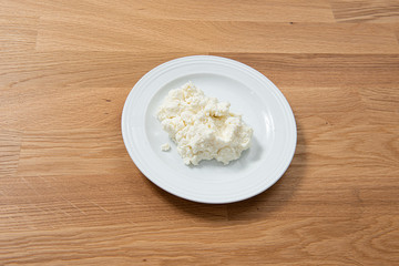Plate of mozzarella on a wooden table.