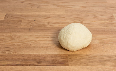 Fototapeta na wymiar Wheat dough rising on a wooden table