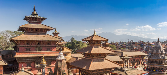 Panorama of temples on Durbar square with mountain background in Patan, Nepal - obrazy, fototapety, plakaty