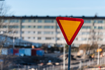 Give way sign in front of a housing complex.