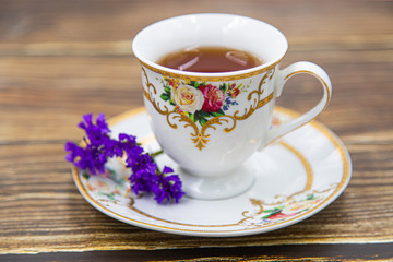 Cup of tea with macaroons on pink background