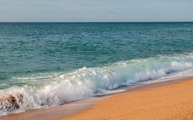 Sea water-wave on the sandy beach at stormy weather