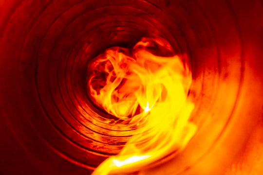 smoke and fire inside the air duct in the ventilation system, the front and back background is blurred with a bokeh effect