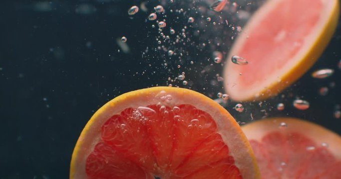 Grapefruit Under water with air bubbles and in slow motion. Fresh and juicy healthy vegetarian.