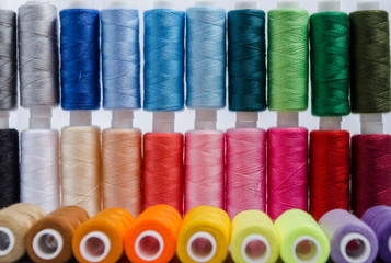 sewing threads different colors, very colorful in background, colorful background