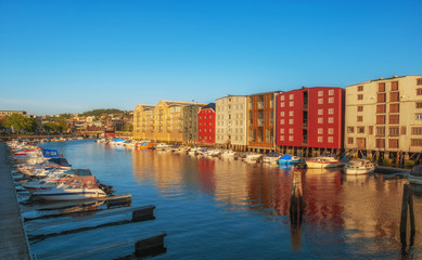 Obraz premium TRONDHEIM, NORWAY - july, 2019: Colorful old houses at the Nidelva river embankment in Trondheim, Norway.
