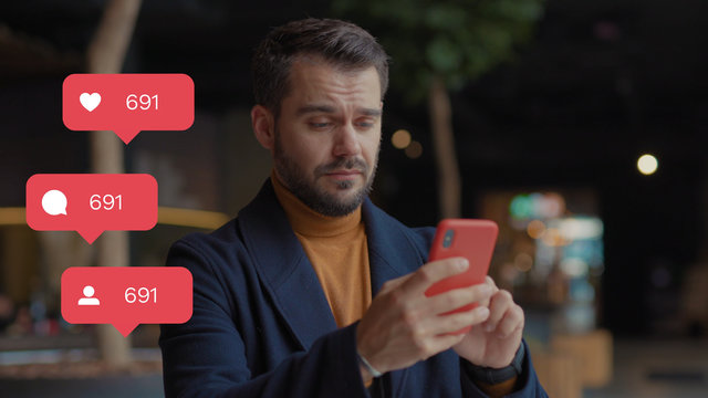 Serious sad young man in shopping mall hold uses smartphone typing social media icons with like comment follower counter quick decrease blogger influencer internet blog slow motion