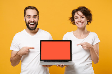 Funny couple friends bearded guy girl in white t-shirts isolated on yellow orange background....