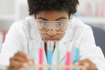 woman with glasses holds samples in her hands
