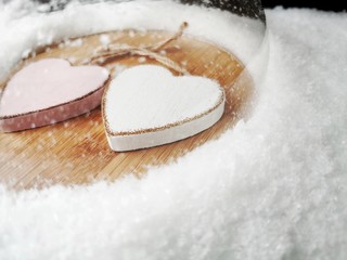 Fototapeta na wymiar Two hearts protected under a glass dome on from snow. Valentine's day concept. Health Care Concept. 