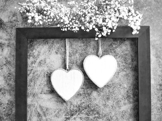 Valentine's Day. Two hearts and flowers on a dark background