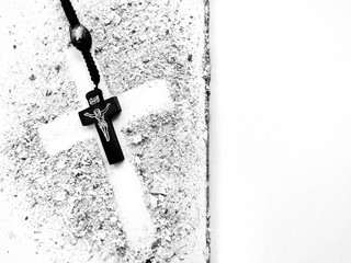 Rosary and Cross of Ash on open book with empty pages. Symbols of Lent.  - Powered by Adobe