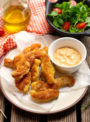 Homemade breaded chicken fingers nuggets with lettuce