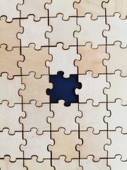 Wooden puzzles background with one different color puzzles piece. World Autism awareness concept.