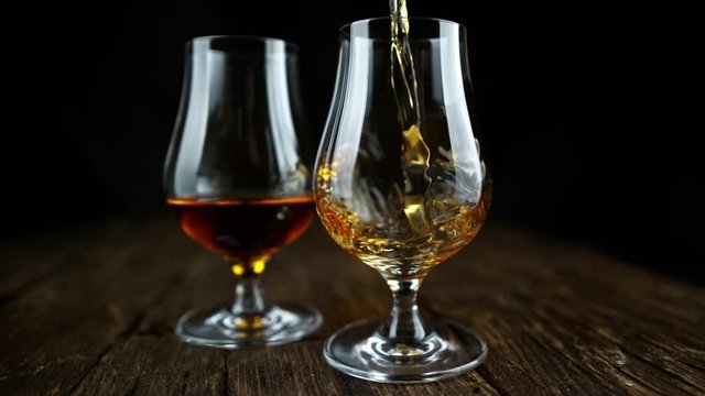 Super Slow Motion Shot of Pouring Rum into Glass at 1000fps with Camera Movement.