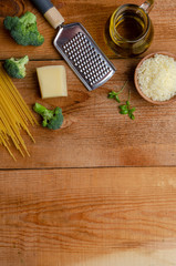Ingredients for italian pasta. Spaghetti, broccoli, parmezan on wooden background