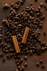 coffee beans, cinnamon sticks and star anise dark background
