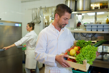 Fototapeta na wymiar chef holding veggies before cooking