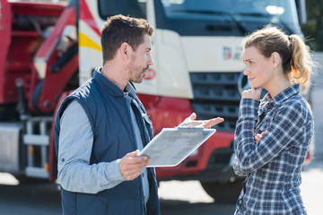 young female driver talking to boss outdoors