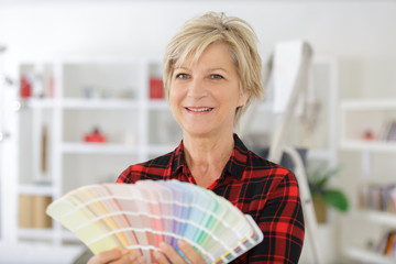 mature woman holding a color swatch