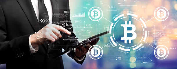 Bitcoin theme with businessman using his tablet computer