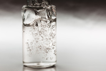 Macro photo of bottle with fluid collagen of hyaluronic acid