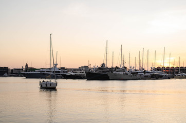 Boat Sailing Calmly At the Port Sea in Sunset 