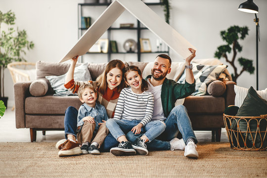 Concept Housing A Young Family. Mother Father And Children In  New Home.