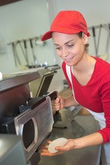 portrait of female butcher processing meat