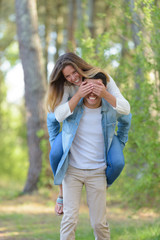 young couple doing piggyback while walking