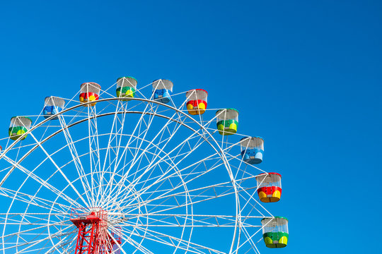 Ferris wheel on clear blue sky background