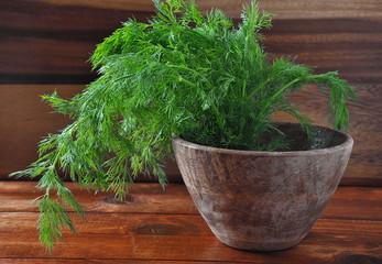 Fresh dill on wooden background