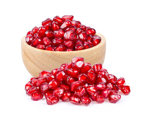 Pomegranate seeds in wood bowl isolated on white background