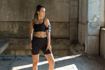 A young slim athletic girl in sportswear with snakeskin prints performs a set of exercises. Fitness and healthy lifestyle.