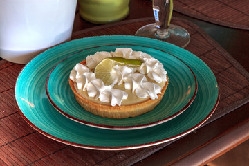 Green keylime pie dessert on a blue plate