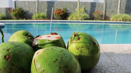 Green coconut water by the pool - 3 - Powered by Adobe