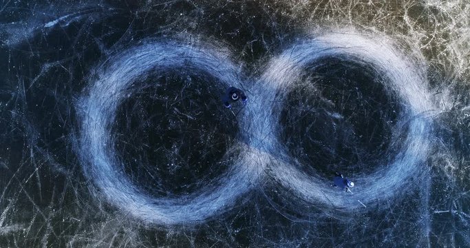 Father and son ice skating circles, infinity symbol