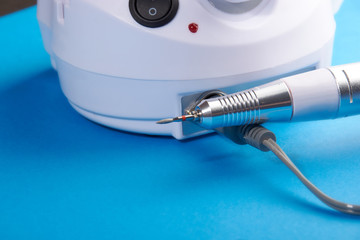 manicure tools on a blue background.scissors, pusher, cutter, saw, machine