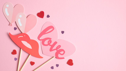 Happy Valentine's Day card template. Top view stylish Valentines Day decorations on pink background. Creative design for party invitation, greeting card. Love and romance concept.