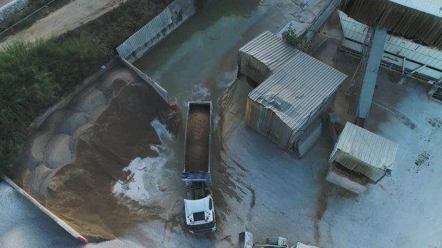 Aerial Drone over cement factory. Trucks loading and pouring sand. Building Industrial footage