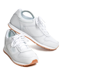 Pair of New White Sneakers Over White Background.