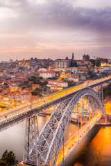 Travel Concepts. Dom Luis I Bridge in Porto in Portugal During Golden Hour With Passing Metro Lanes. © danmorgan12