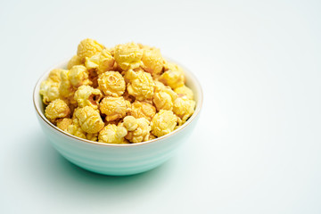 A bowl of caramel and cream flavored popcorn snack. A bowl of popcorn