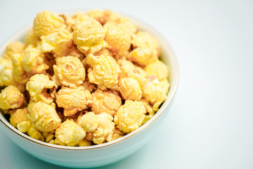 A bowl of caramel and cream flavored popcorn snack. A bowl of popcorn