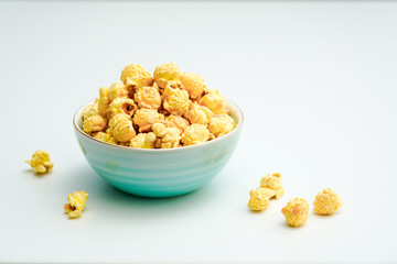 A bowl of caramel and cream flavored popcorn snack. A bowl of popcorn