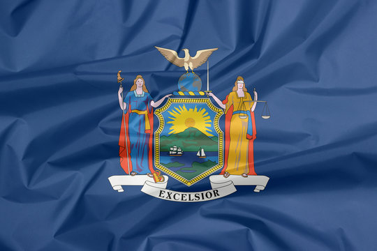 Crease of New York fabric flag background, coat of arms of the state of New York on blue field.