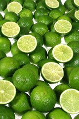 Group of green lemons whole and cut