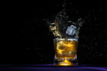Beverage splash with spills out of glass